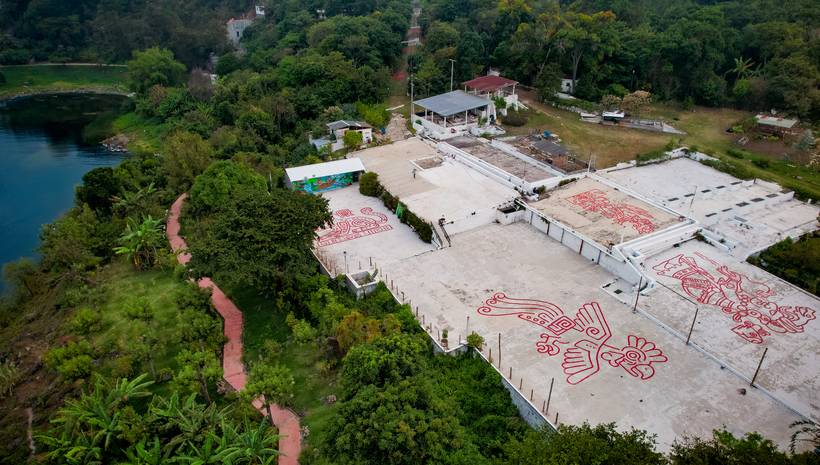Coffee patios with Maya engravings seen from a drone, beside the lake